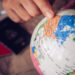 close-up pointers at the globe, tourists are planning to find attractions - Conception Travel